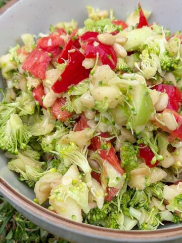 Crunchy broccoli apple salad with honey mustard dressing in a bowl.